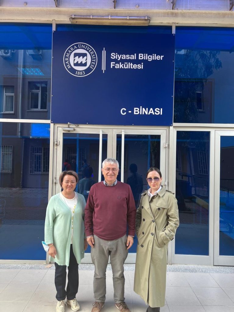 3 people standing in front of the building of Marmara University