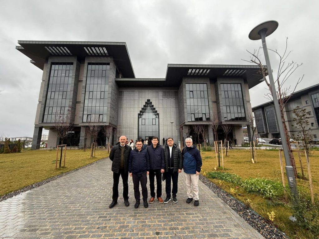 people posing in front of a modern building