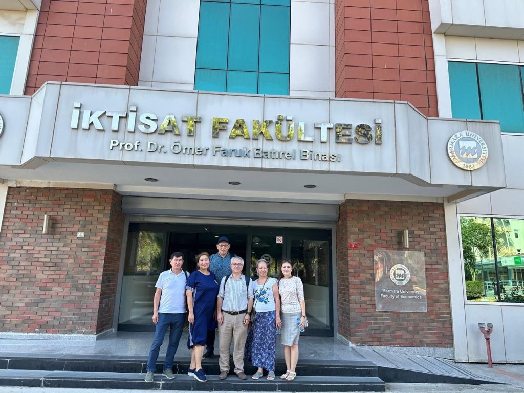 People posing for a photo in front of the building