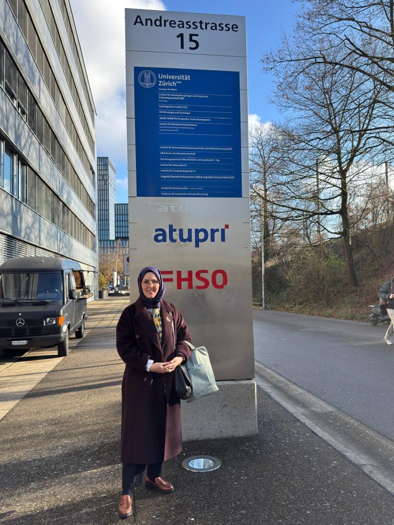 Busra in front of the building of the department 