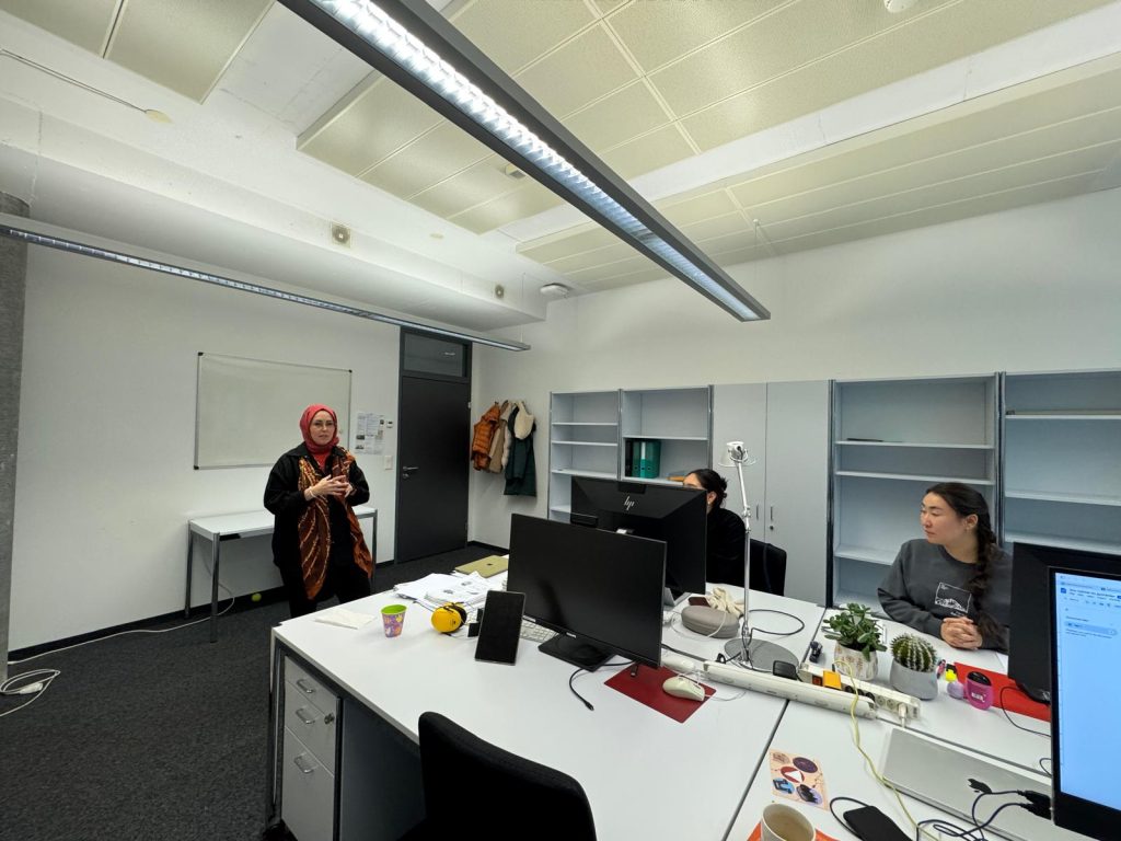 Busra speaking in front of the PhD students